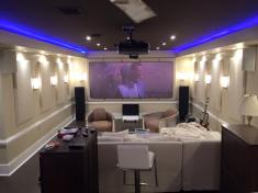 Elite Custom Audio Video installed the lighting, speakers, large projector for the TV, surround sound, acoustics and furniture to create this home theater.